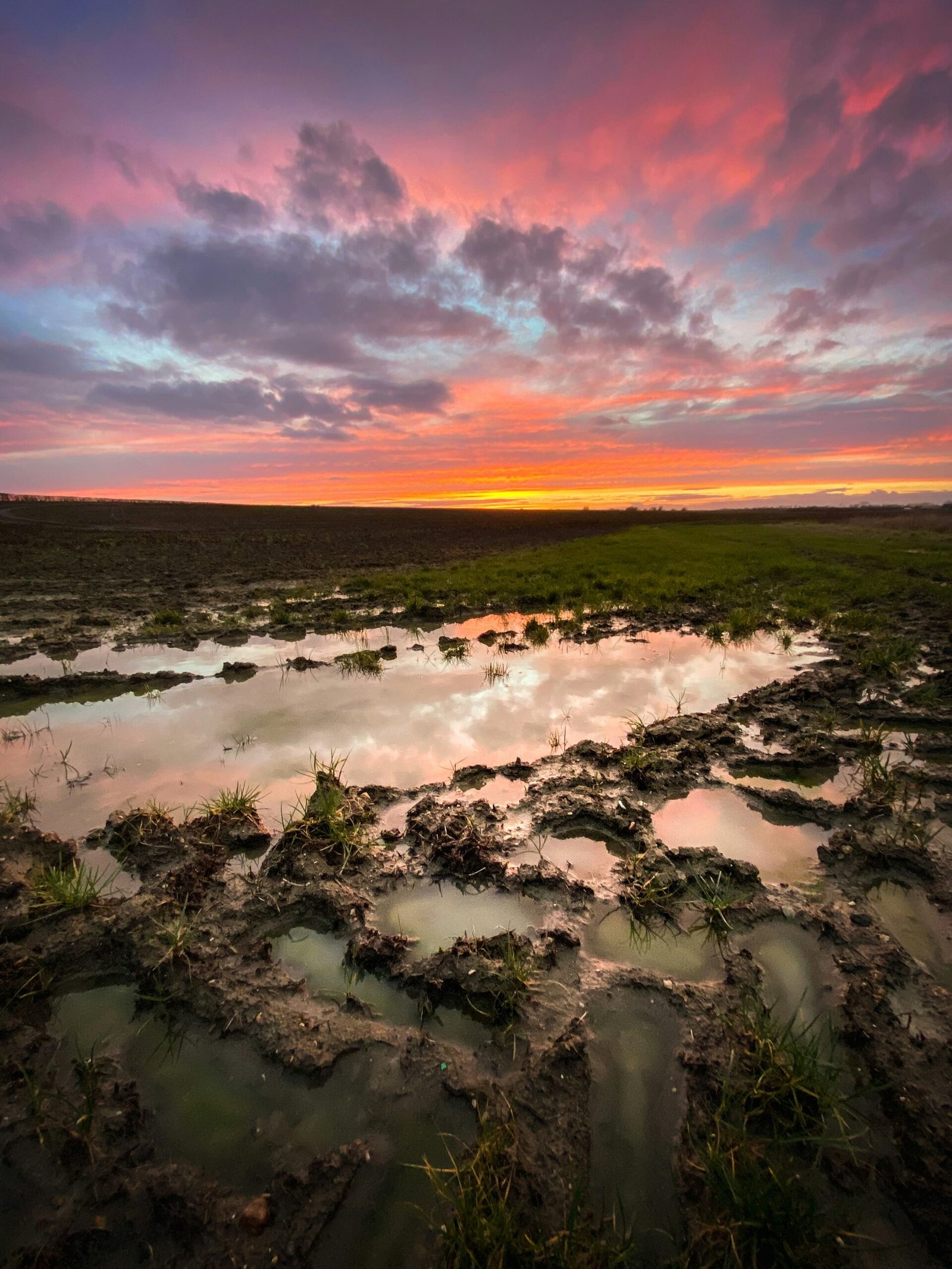 body of water under cloudy sky during sunset