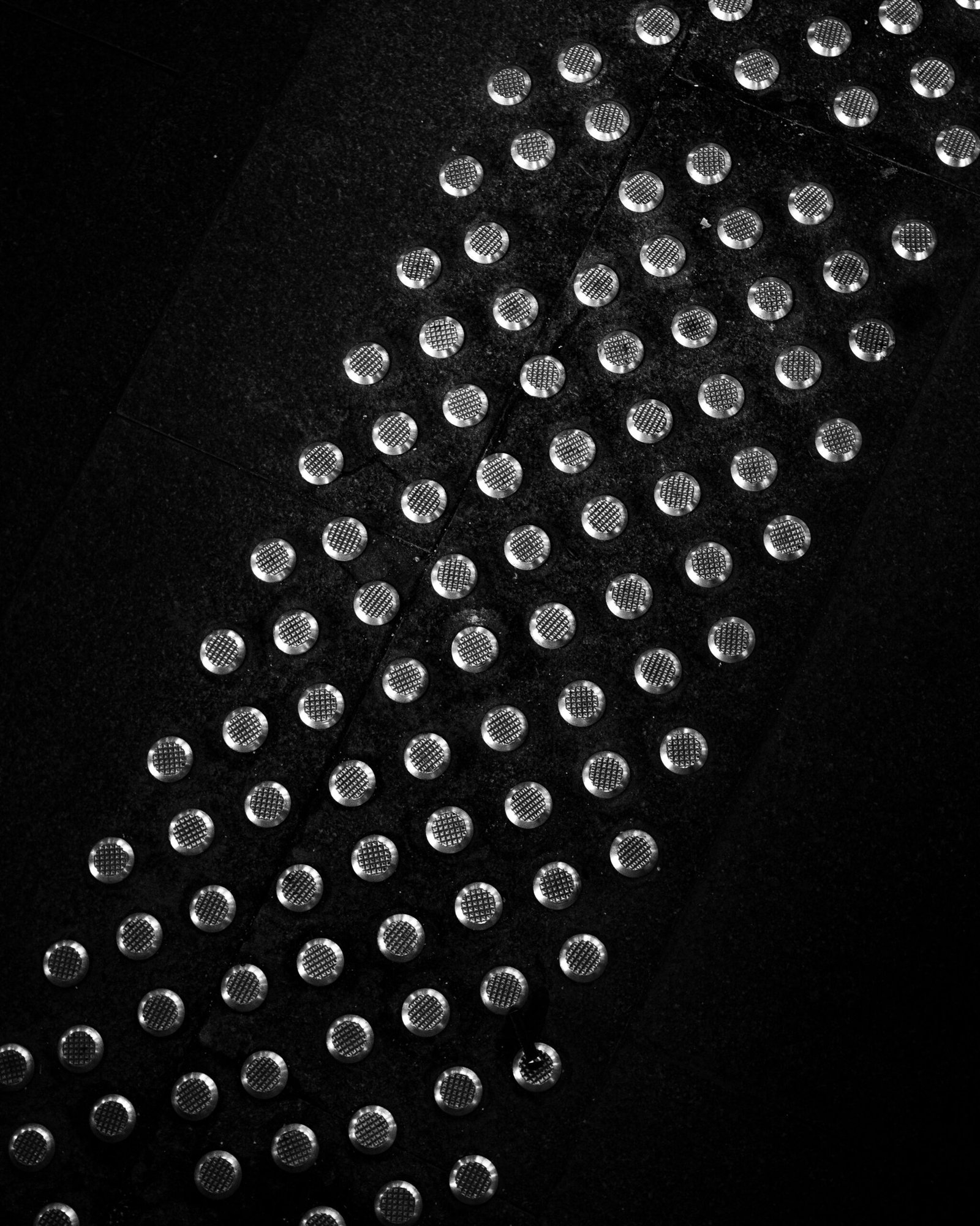 a black and white photo of a tie with lots of dots on it