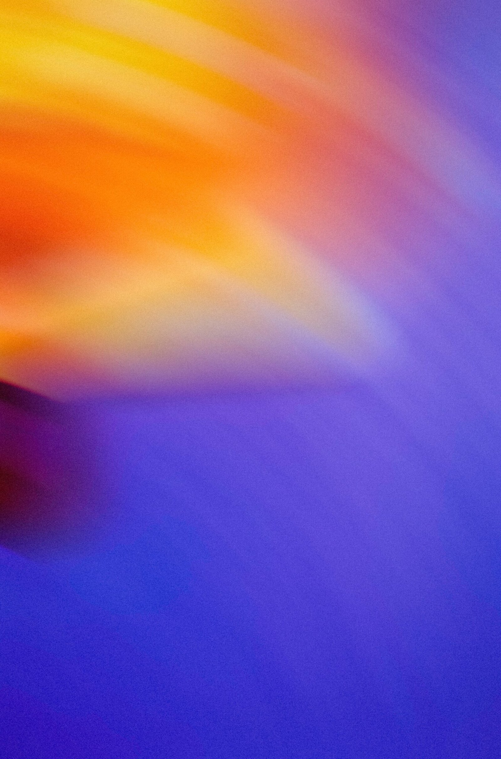 a blurry photo of a purple and yellow object